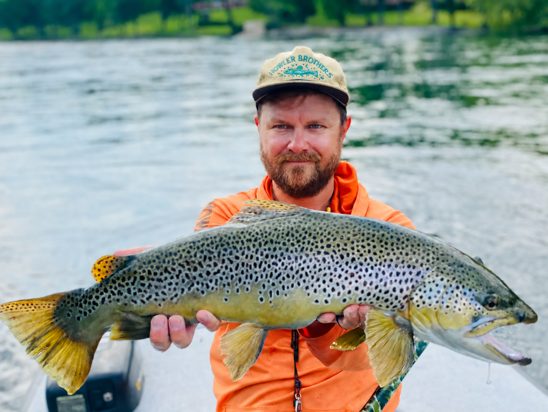 Brad Sperry holding a large White River brown trout